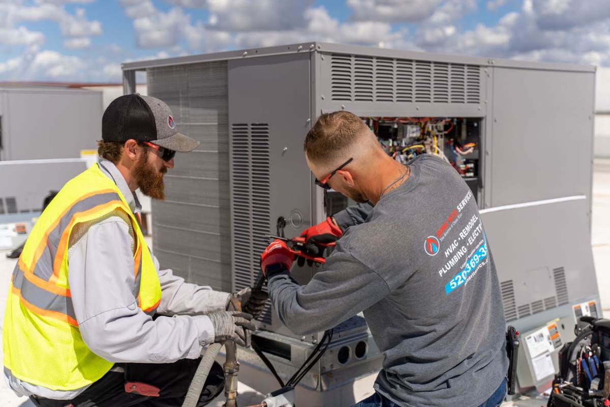 Done Rite technician servicing rooftop air conditioning equipment in Tucson